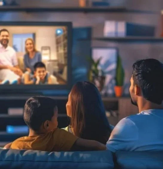 Family watching live TV channels through IPTV service at home